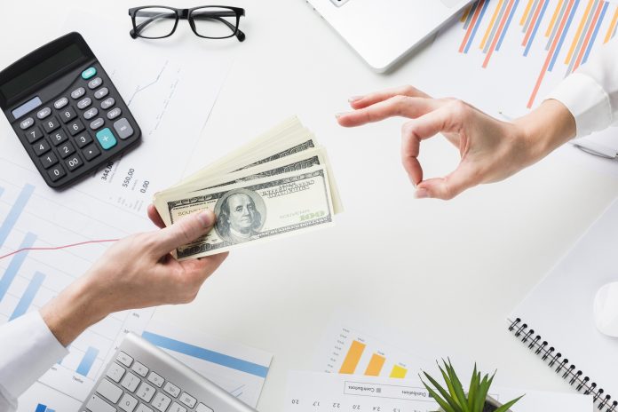 top-view-hand-accepting-money-desk
