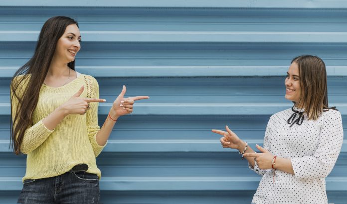 medium-shot-girls-pointing-each-other