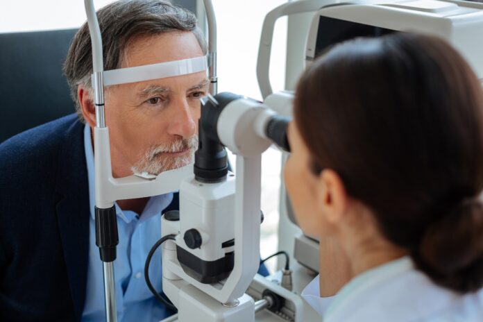 Nice aged man putting his head in a special device El glaucoma avanza sin síntomas en sus etapas iniciales